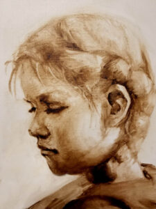 a sepia-toned portrait of a young child with braided hair.